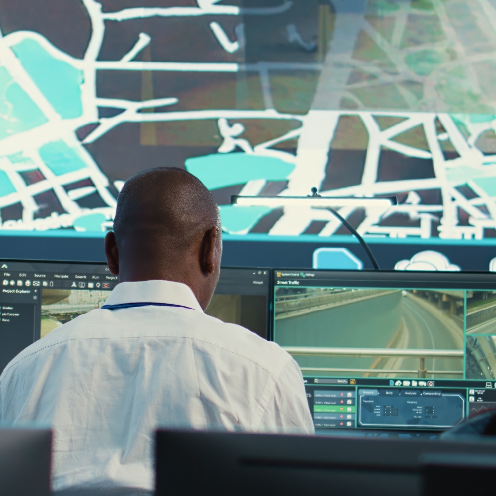 Man monitors urban traffic on computer screens