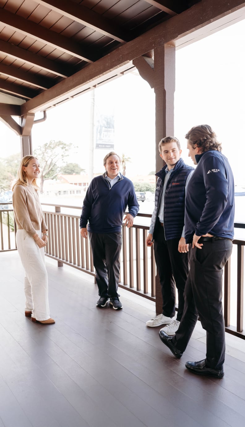 Group of coworkers talking on outdoor balcony