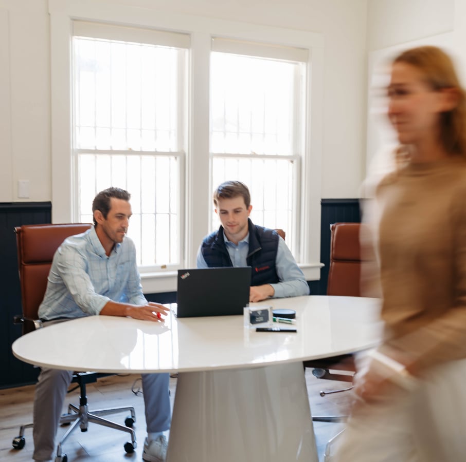 Business meeting with two men and woman passing