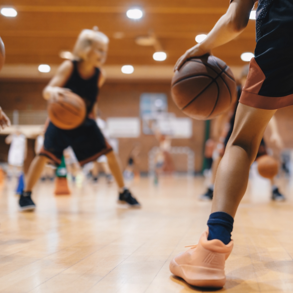 Children playing basketball in an indoor gym