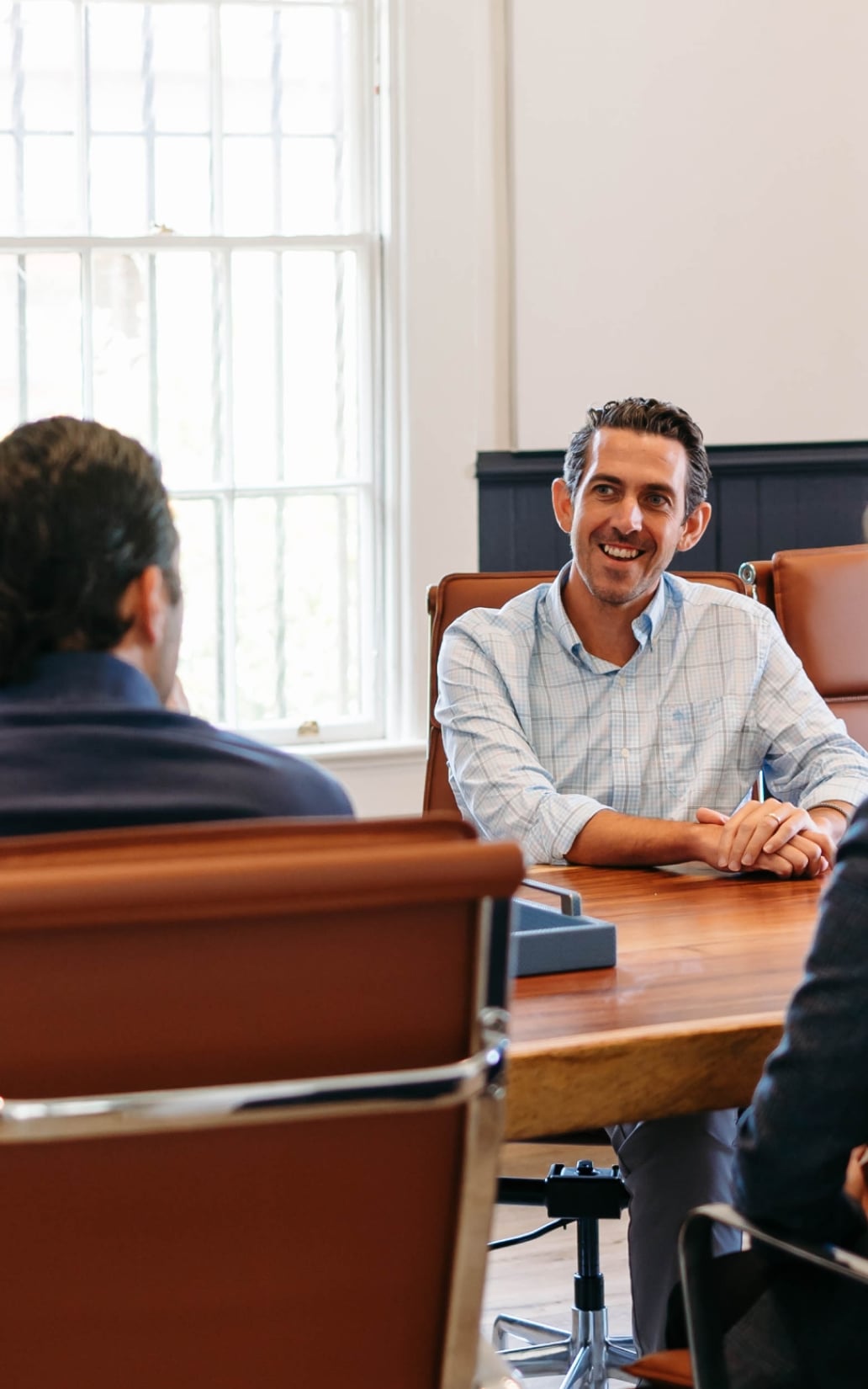 Man smiling during an office meeting discussion