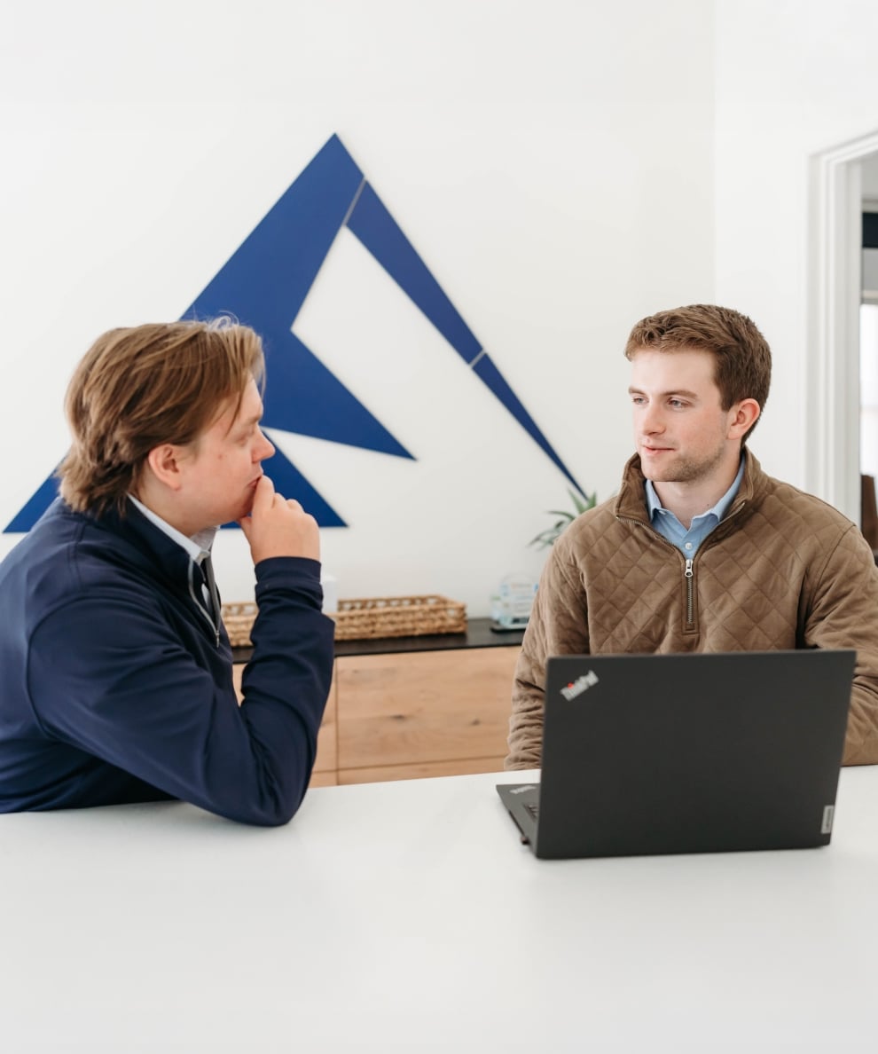 Two men discussing business at office desk